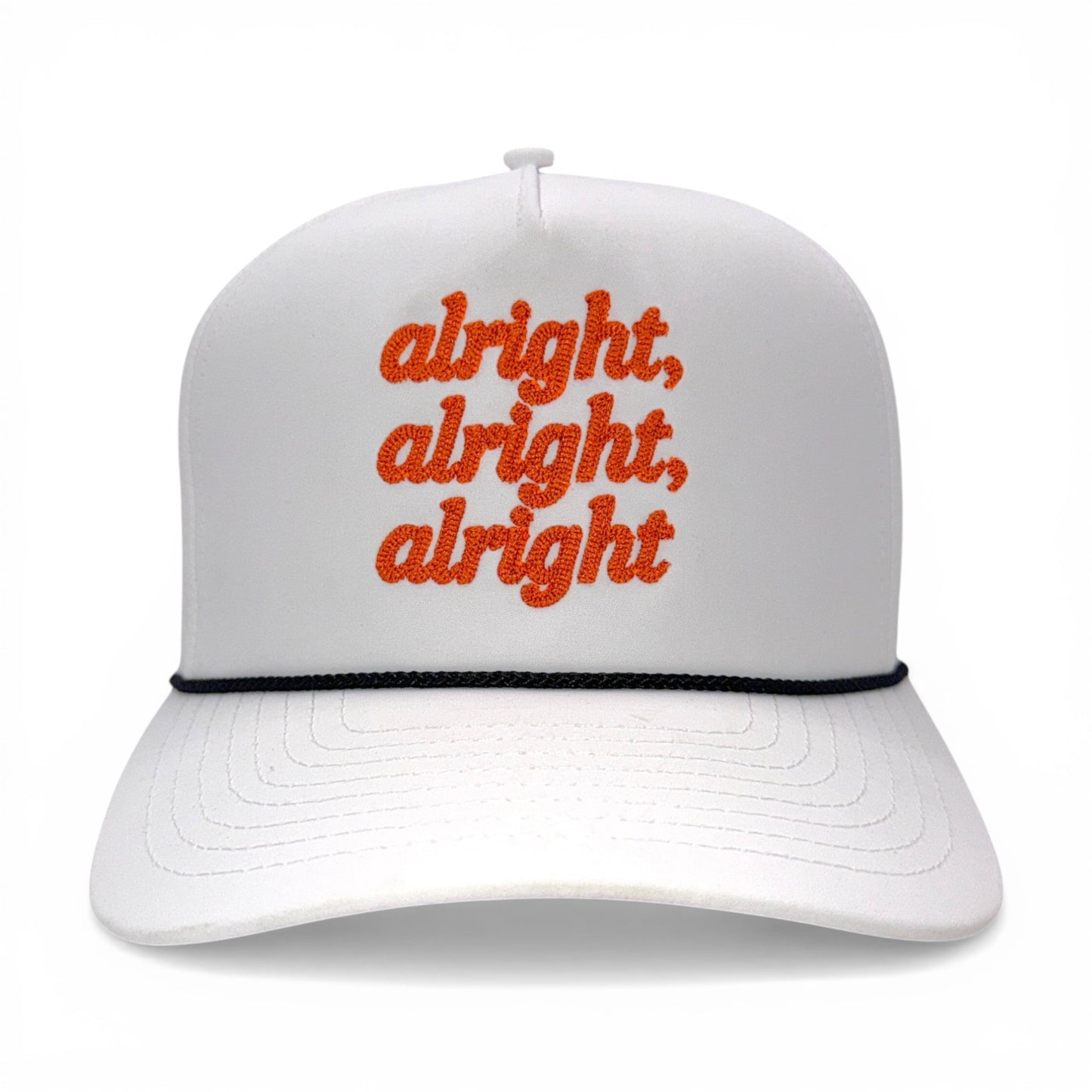 Front view of white rope hat with orange “alright, alright, alright” embroidery and black rope