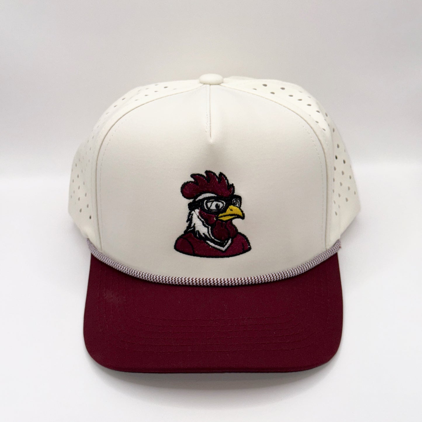 White and maroon cap with a rooster logo on a white background