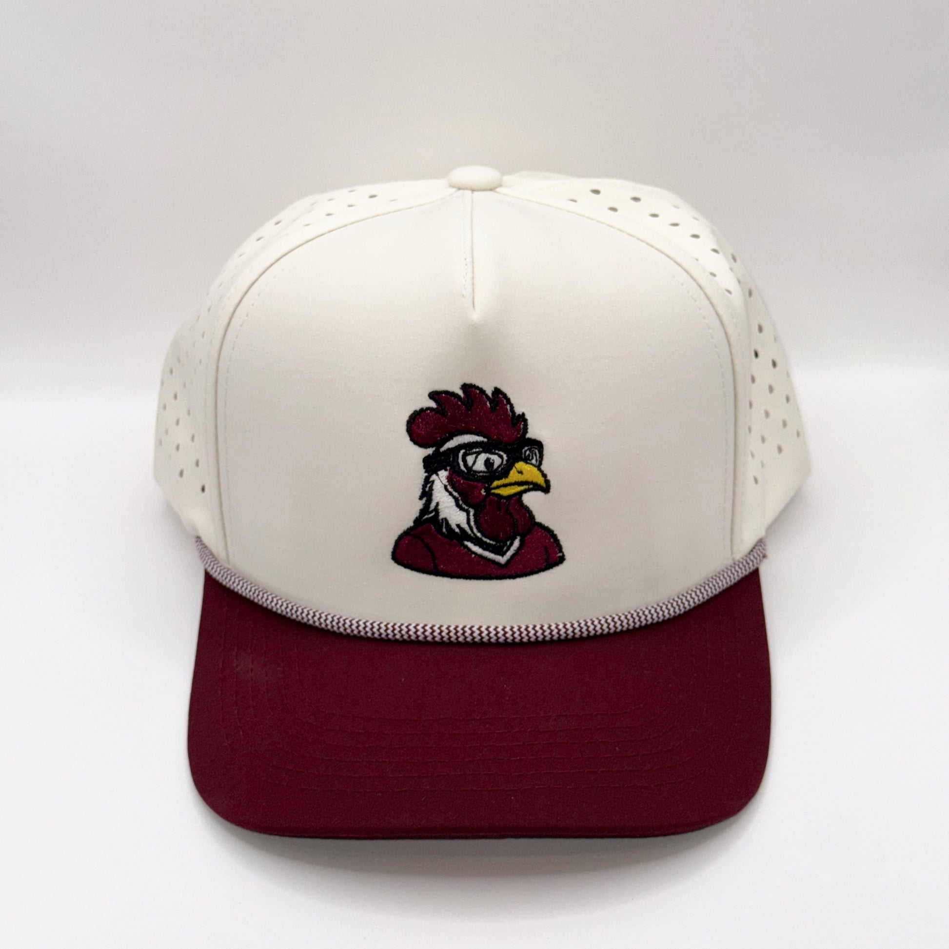 White and maroon cap with a rooster logo on a white background