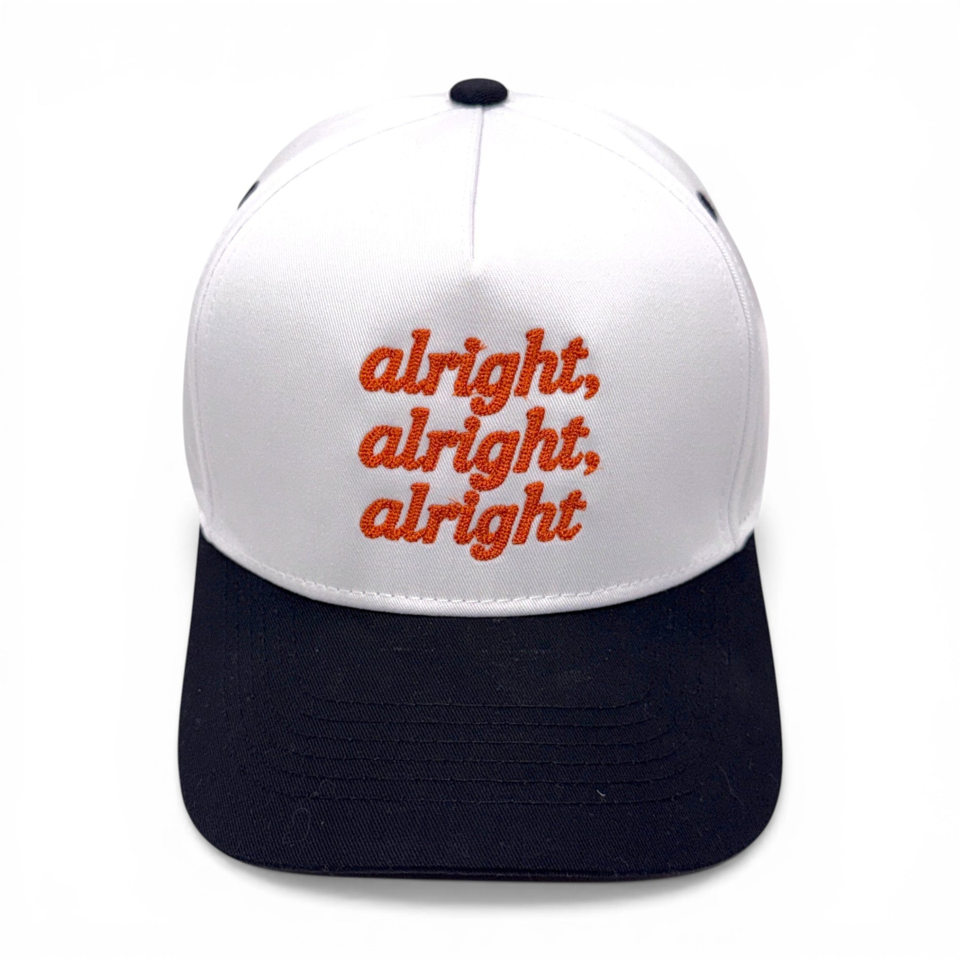 White and black cap with red text 'alright, alright, alright' on a white background