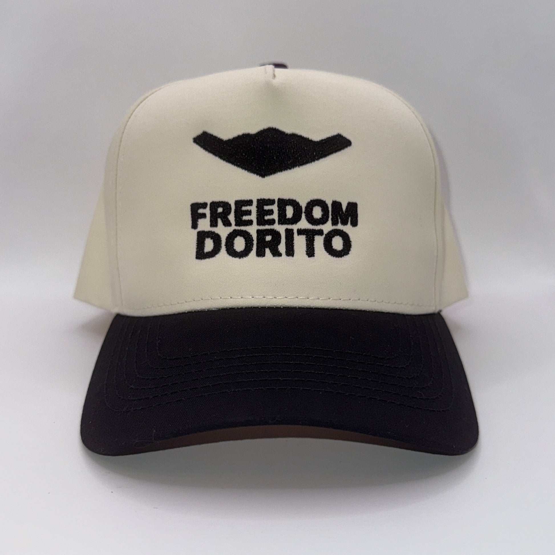 Cream and black snapback hat with embroidered B2 bomber silhouette and text ‘Freedom Dorito’