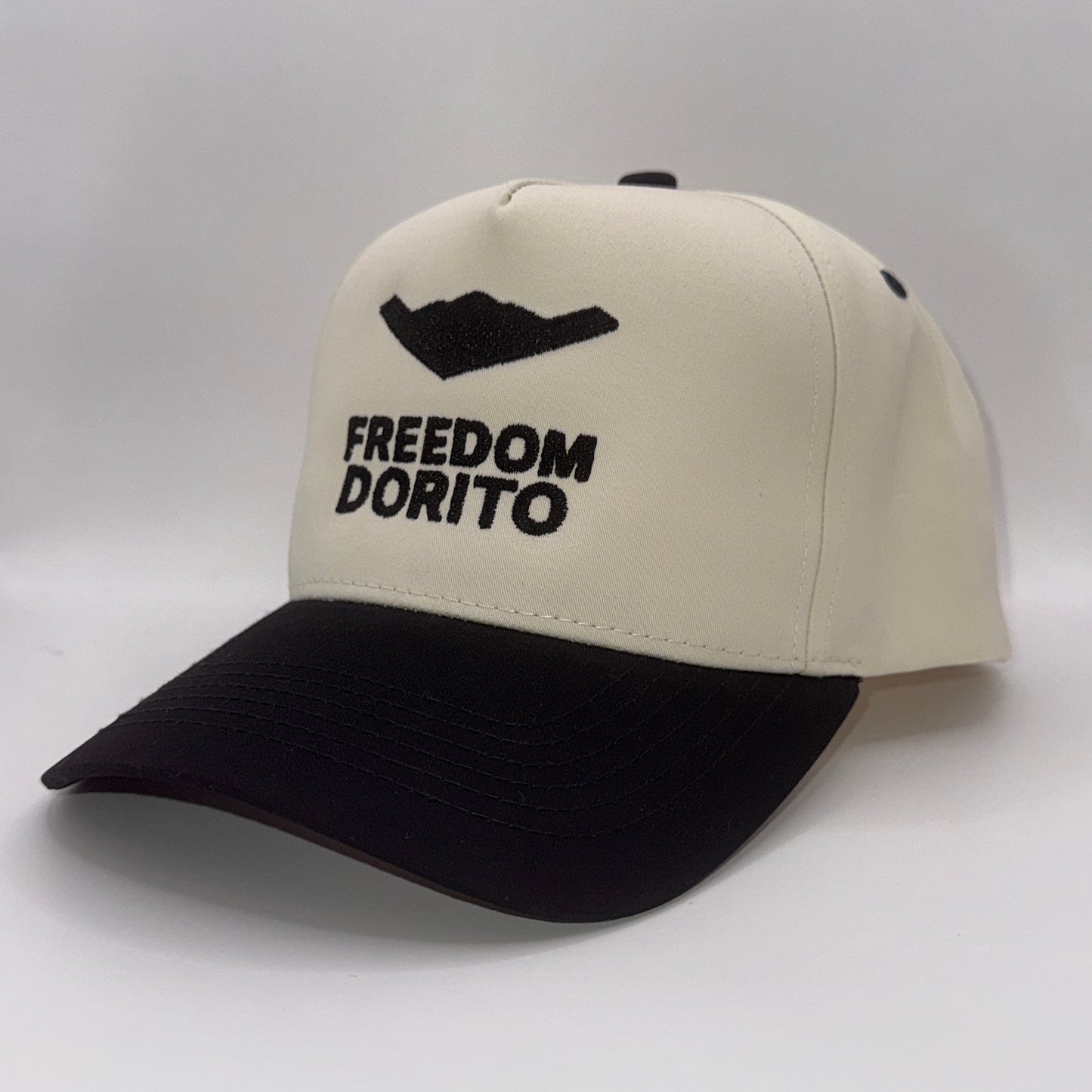 Cream and black snapback hat with embroidered B2 bomber silhouette and text ‘Freedom Dorito’