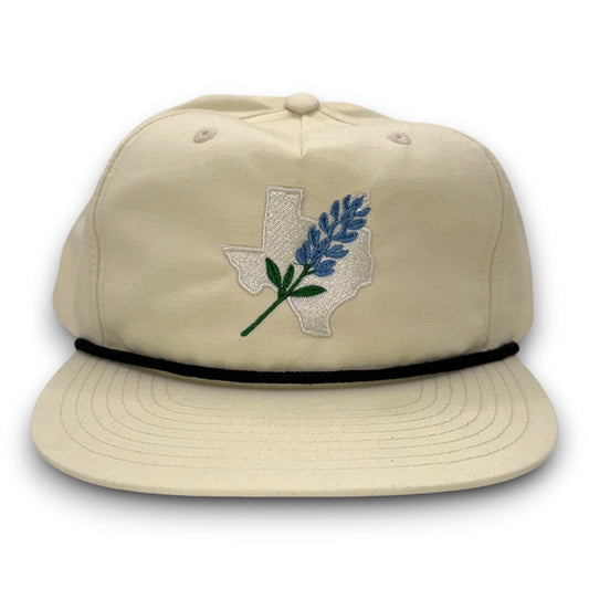 Beige cap with embroidered design on a white background