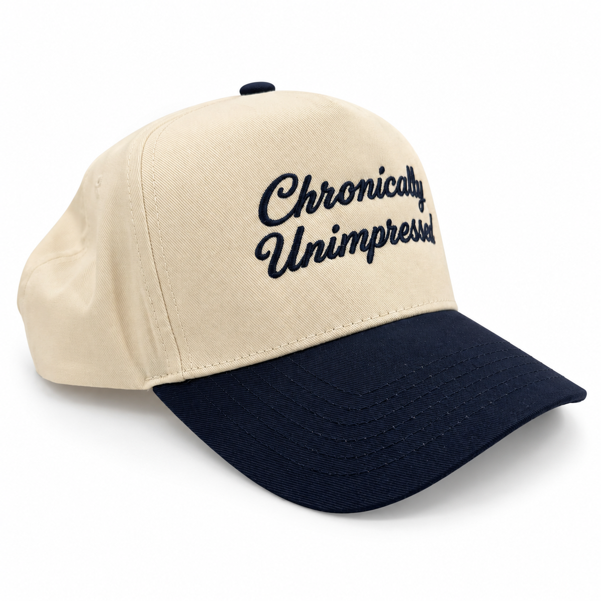 Mad Capper Chronically Unimpressed Classic hat in Natural/Navy, three-quarter view with navy script embroidery