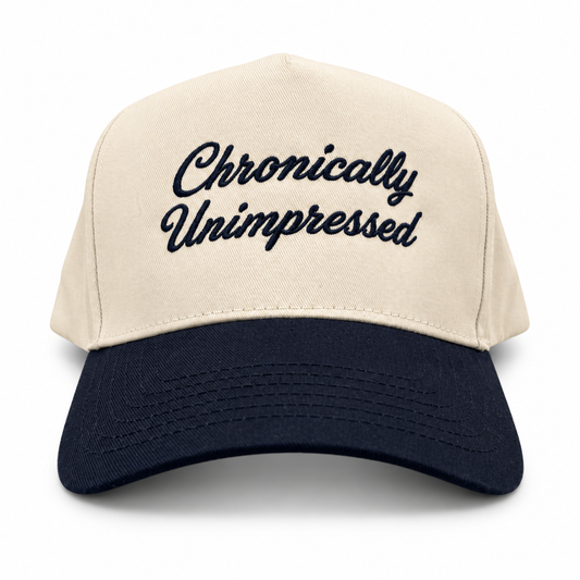 Mad Capper Chronically Unimpressed Classic hat in Natural/Navy, front view with navy script embroidery