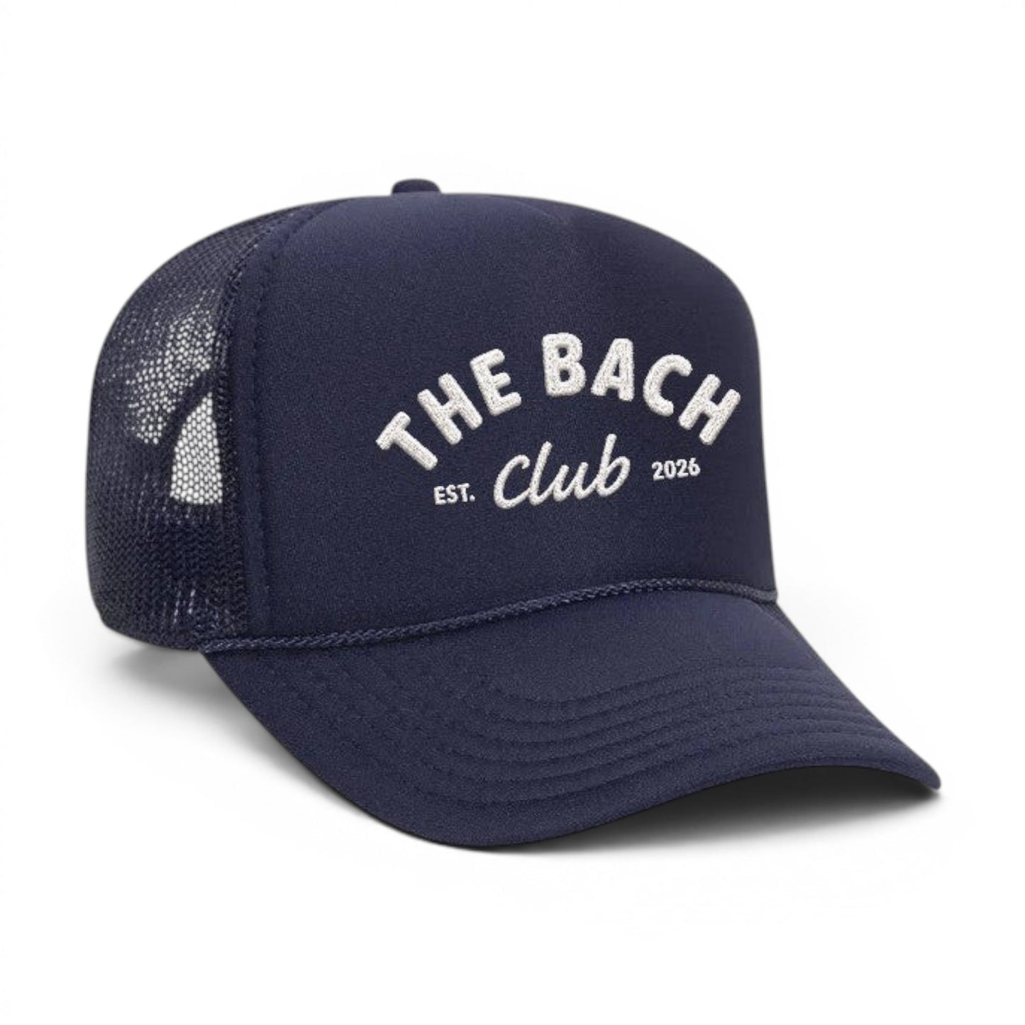 Mad Capper navy blue trucker hat with "The Bach Club EST. 2026" embroidered on the front and mesh back panels.
