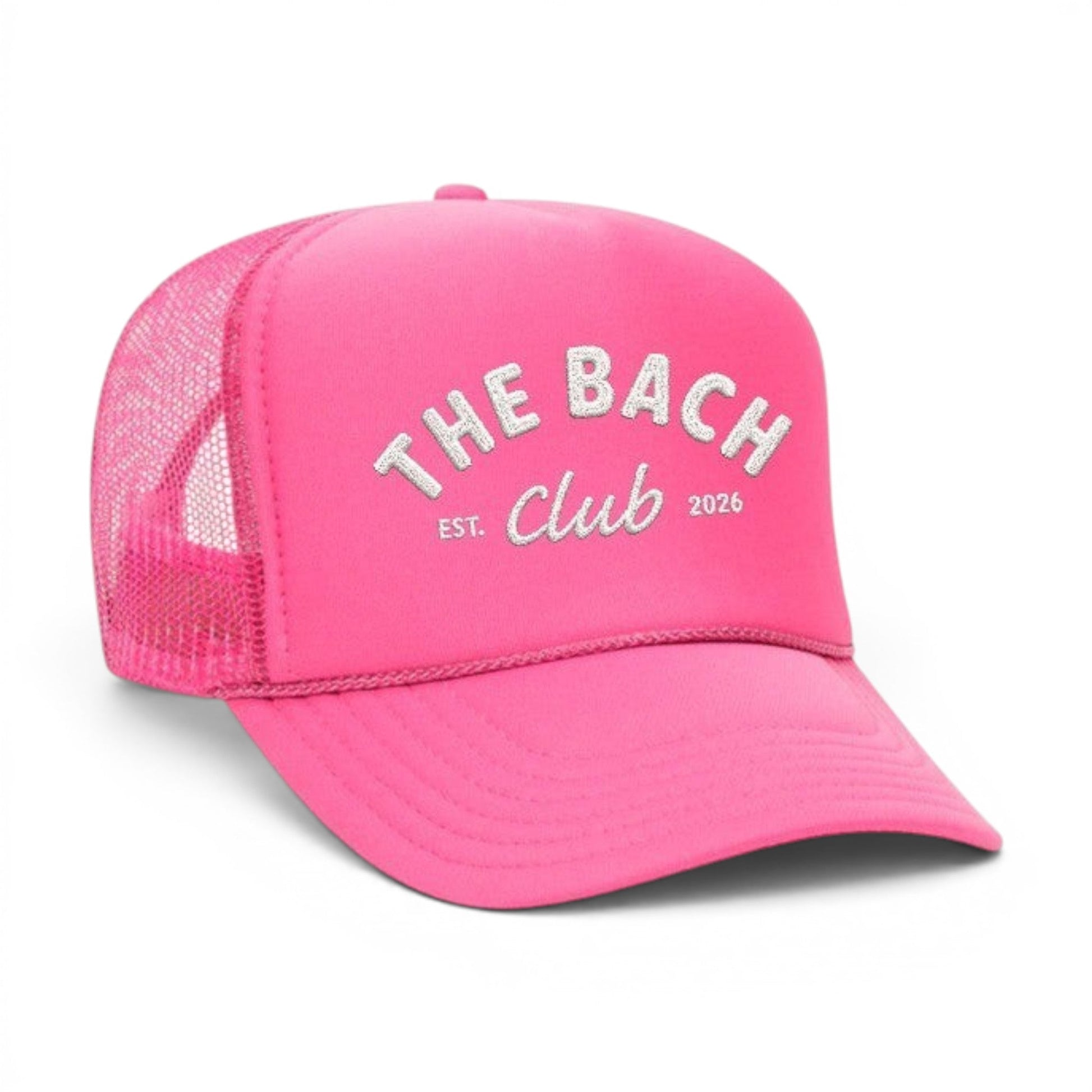 Mad Capper hot pink trucker hat with "The Bach Club EST. 2026" embroidered on the front. Mesh back for breathability.