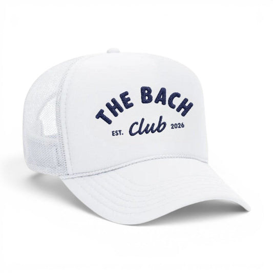 Mad Capper white trucker hat with navy blue embroidery reading "The Bach Club EST. 2026". Mesh back for breathability.