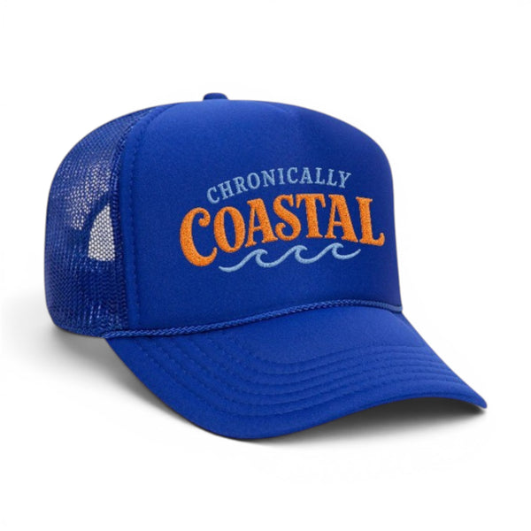 Mad Capper blue foam trucker hat with "CHRONICALLY COASTAL" embroidered in orange and light blue waves.
