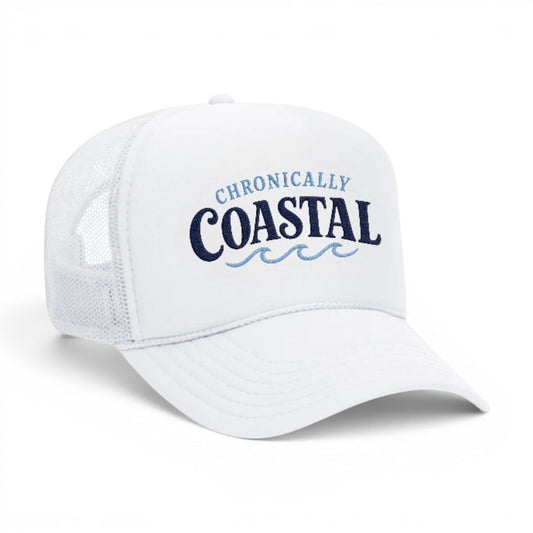Mad Capper white trucker hat with navy blue "CHRONICALLY COASTAL" embroidery and light blue waves. Mesh back for breathability.