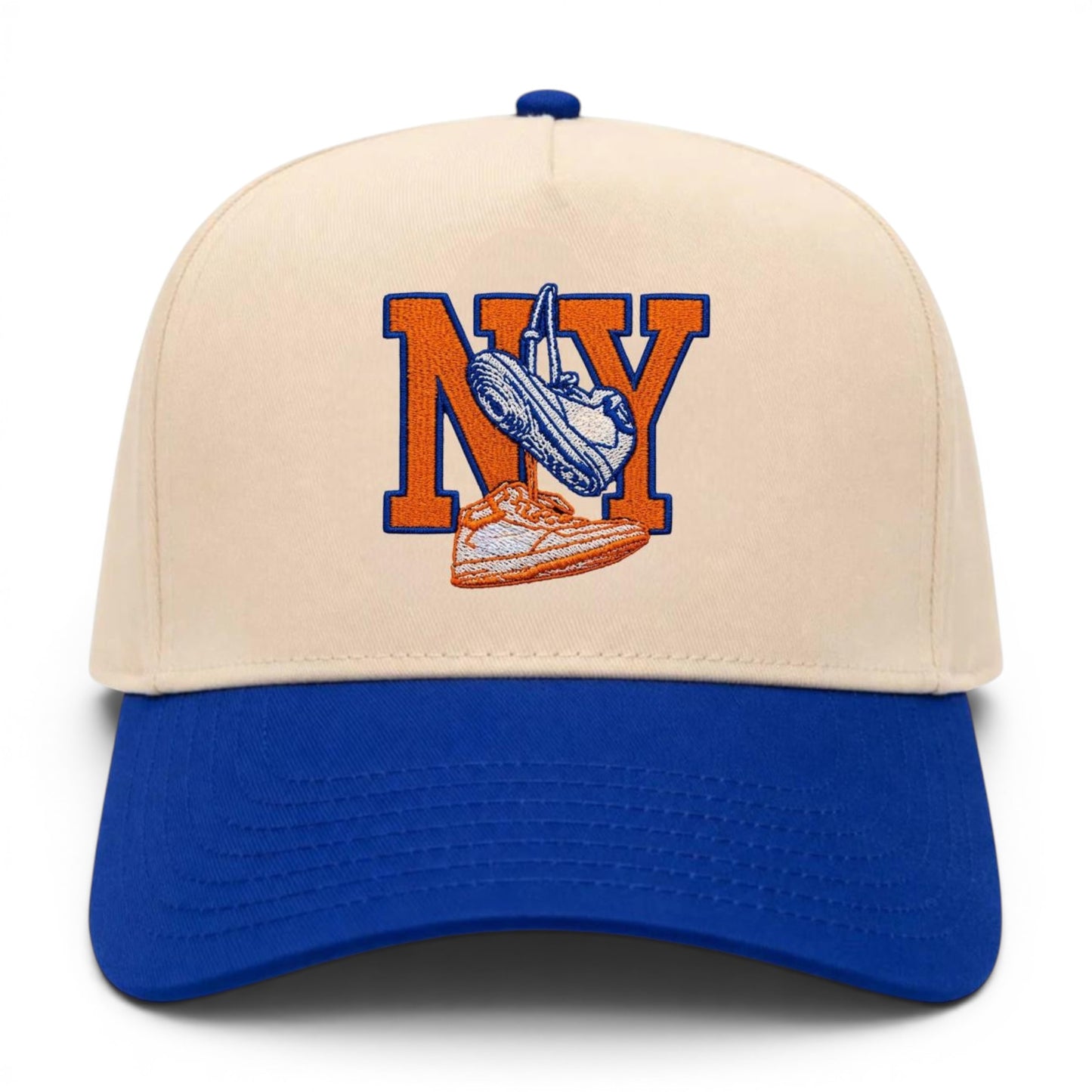 Mad Capper New York Kicks hat with embroidered NY and sneakers on a cream crown and blue brim.