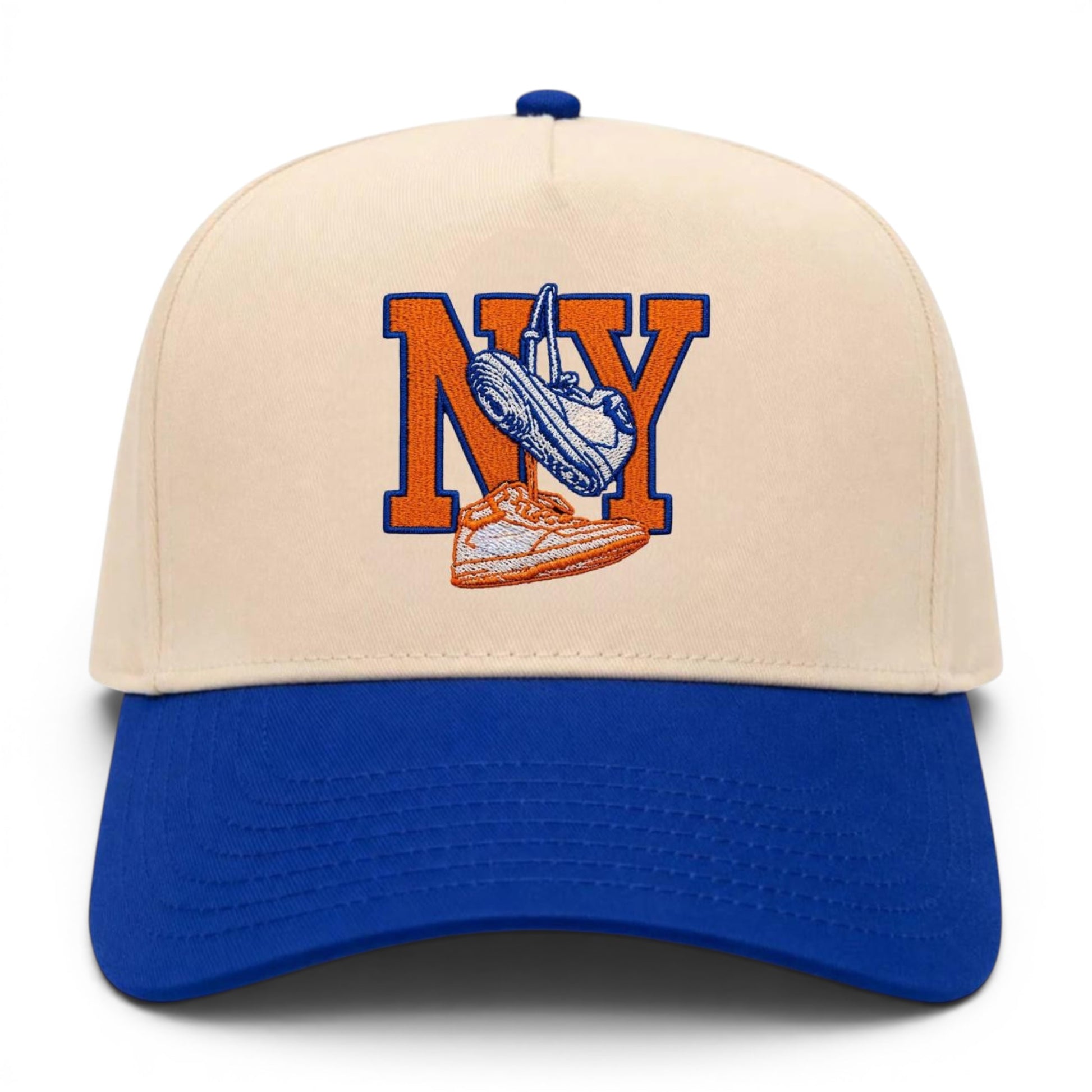Mad Capper New York Kicks hat with embroidered NY and sneakers on a cream crown and blue brim.