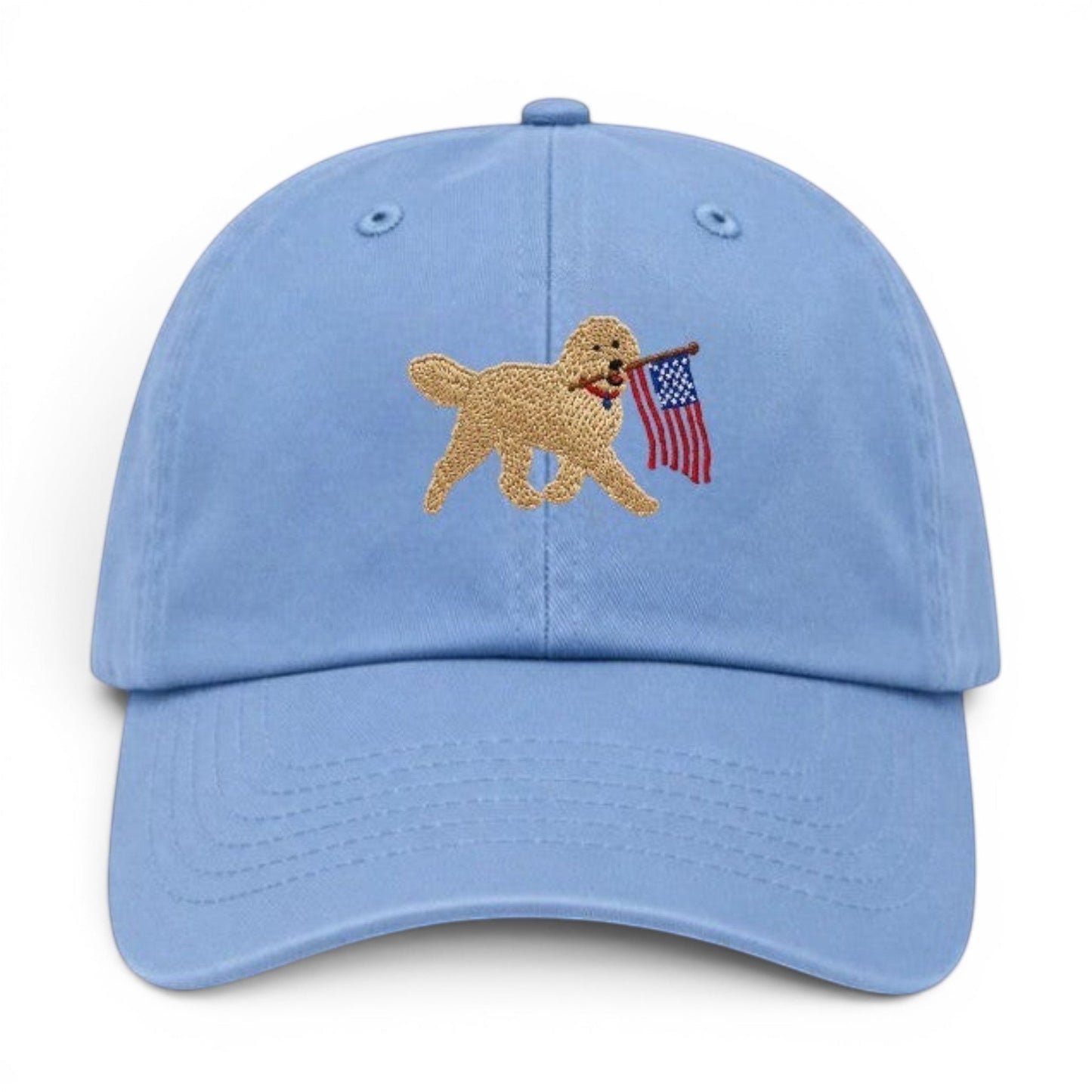 Mad Capper light blue embroidered hat with a golden doodle carrying the American flag.