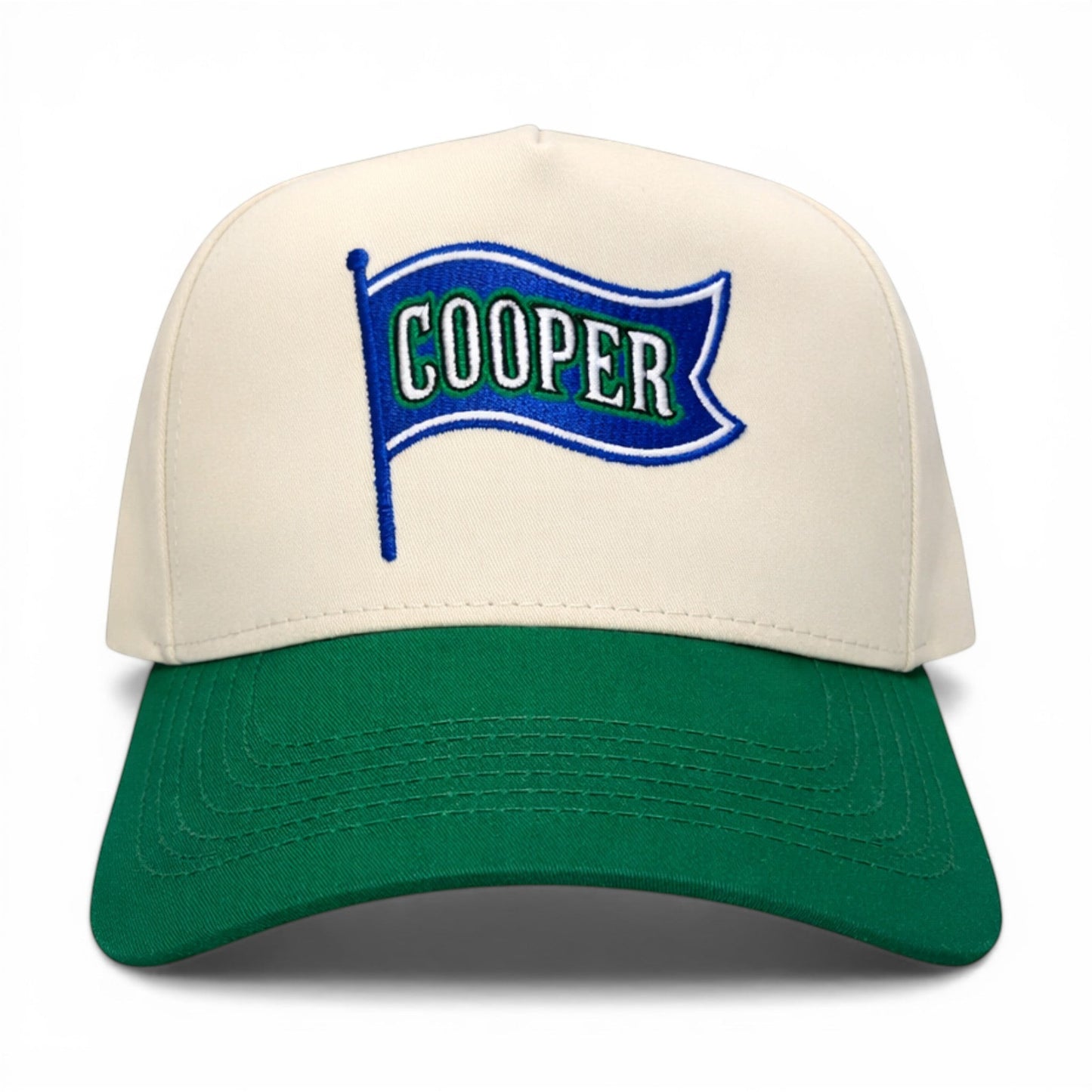 Mad Capper Flag of COOPER hat with cream crown and green brim, featuring embroidered flag graphic with "COOPER" text.
