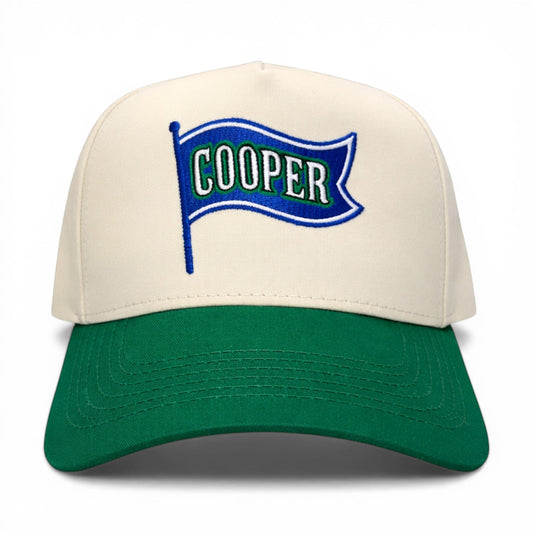 Mad Capper Flag of COOPER hat with cream crown and green brim, featuring embroidered flag graphic with "COOPER" text.