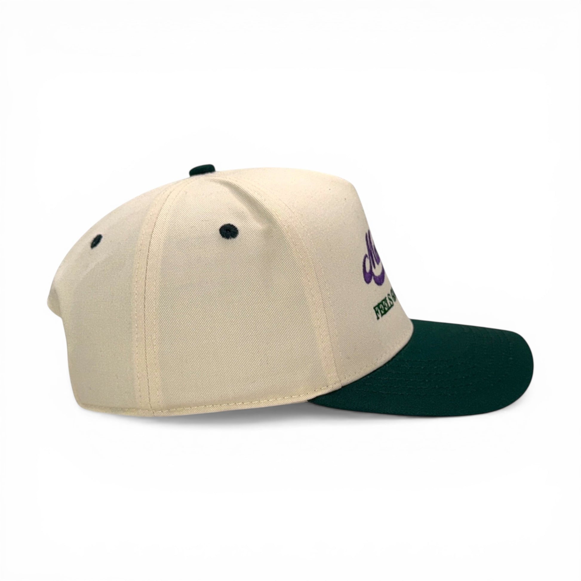Mad Capper Mardi Gras King Hat in cream with dark green brim and purple embroidery. Adjustable fit.