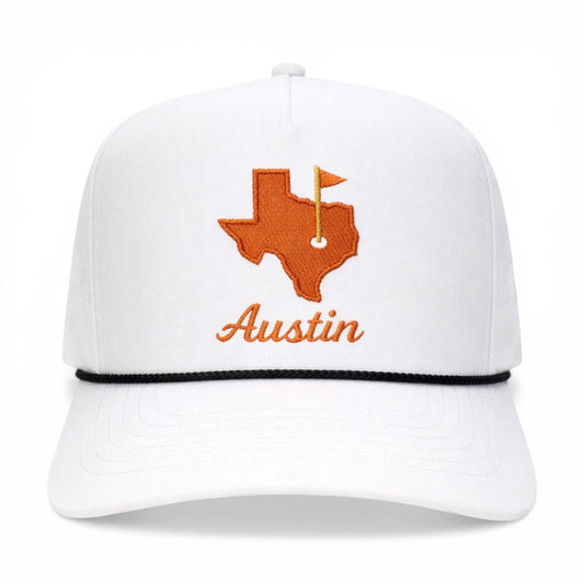 Mad Capper white trucker cap with embroidered orange Texas map logo and "Austin" text. Features a black rope detail.